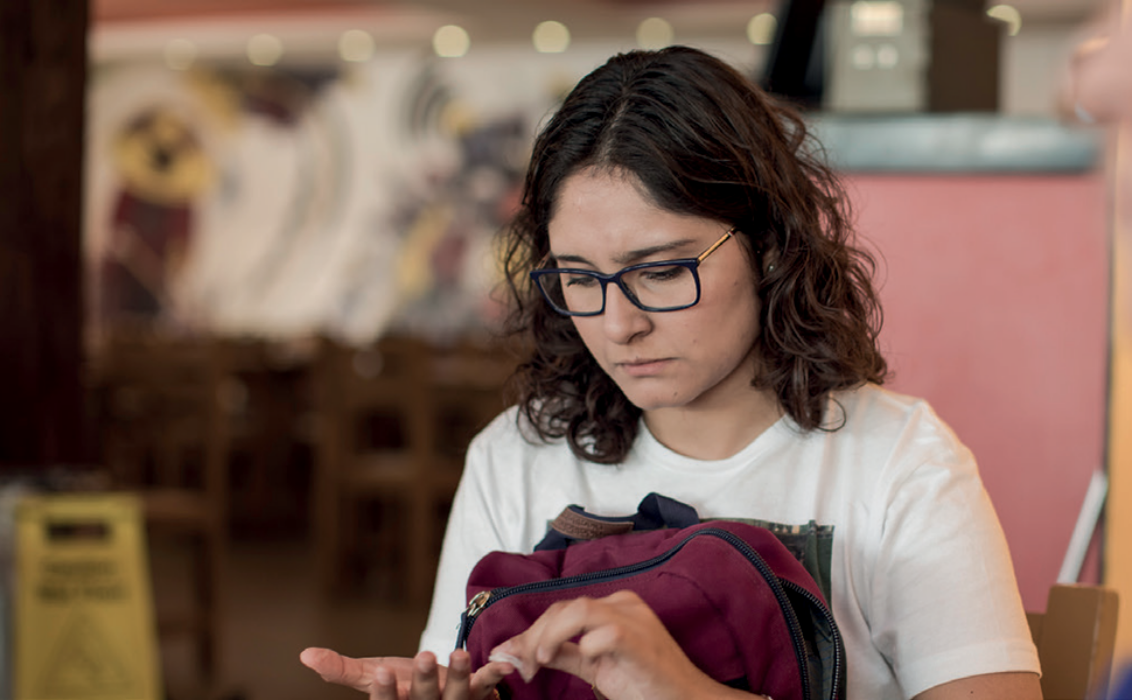 Young girl testing her glucose with a finger prick.