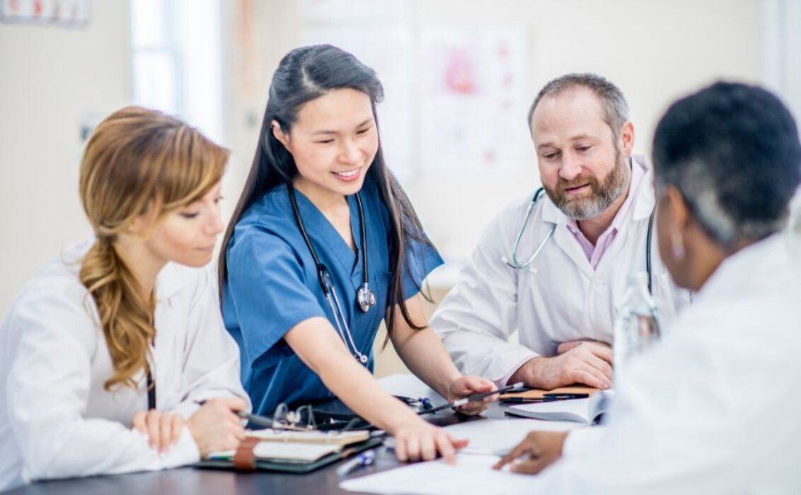 Doctor going over charts with colleagues